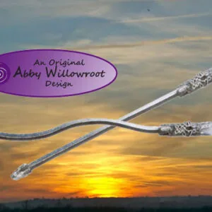 Two decorative wands with ornate silver handles and blue cord connecting them, displayed against a sunset sky