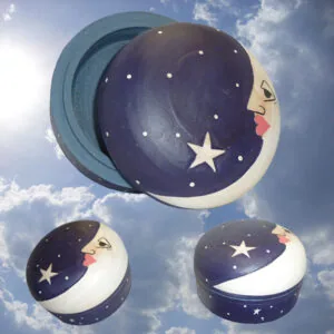 Three decorative crescent moon and star boxes in varying sizes against a blue sky with clouds