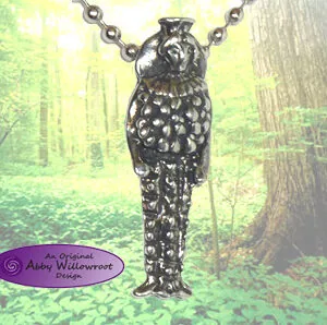 Pewter pendant of Diana of Ephesus on chain, hanging against forest background