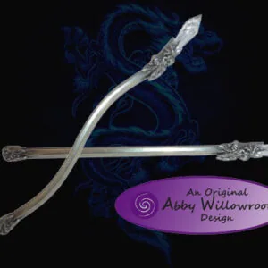 Two ornate silver wands crossed against dark blue swirled background with purple oval logo reading "An Original Abby Willowroot Design"