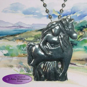 Pewter horse pendant on ball chain displayed against watercolor landscape painting