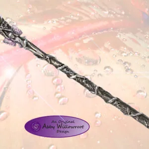 Black wand with crystalline sphere at tip on translucent pink surface with water droplets