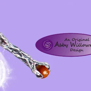 Pewter wand pendant with amber teardrop stone on purple background