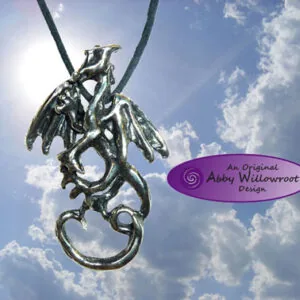 Pewter dragon pendant with wings and tail hanging from black cord against sky with clouds