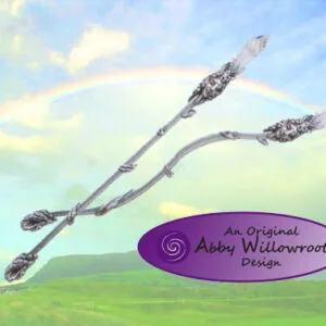 Two intertwined silver-toned wands with ornate handles against a sky and green landscape background