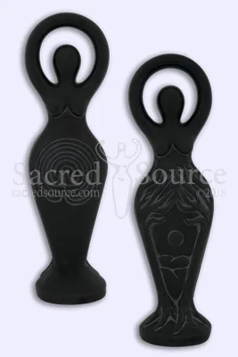 Two black stone goddess figurines with crescent moon heads and carved details on light background