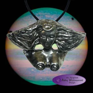 Pewter pendant depicting a winged goddess face with black cord against a colorful circular background