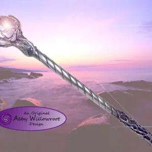 Ornate wand with glowing crystal orb against twilight ocean beach backdrop