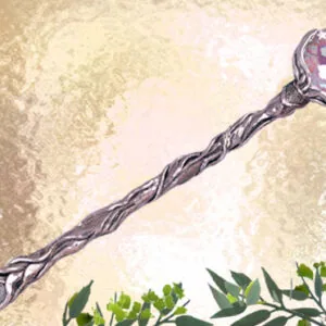 Ornate wand with twisted dark handle and purple crystal head on textured beige background with green foliage