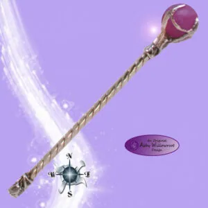 Decorative wand with twisted metal handle and burgundy sphere top against purple background with compass design and white light streaks