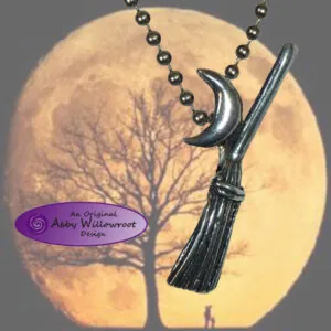 Silver moon crescent and broomstick pendant on beaded chain against full moon background with bare tree