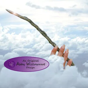 Hand holding a gnarled wooden wand against a cloudy sky background with purple Abby Willowroot Design logo