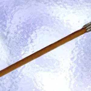 Wooden wand with ornate silver-toned knob handle on textured purple background