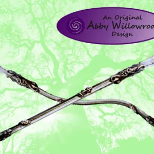 Two wooden wands with black leaf-like wrapping crossed in an X shape against a pale green textured background