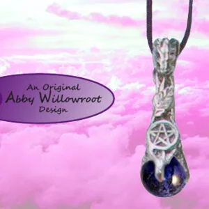 Silver pentacle pendant with dark blue stone hanging from black cord against pink cloudy sky background