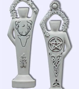 Two white decorative statues with antler and pentacle designs, standing side by side on bases