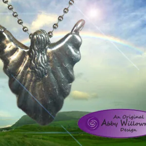 Winged figure pendant hanging from ball chain against cloudy sky and green landscape