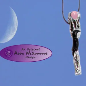 Pewter wand pendant with pink stone top hanging against blue sky with crescent moon