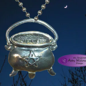 Silver cauldron pendant with star design and chain against night sky with crescent moon