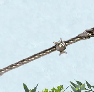 Decorative wand with twisted dark metal shaft, star embellishment, and spherical crystal orb at top against light blue background