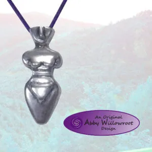 Sterling silver pendant shaped like a female torso on a dark purple cord, displayed against a misty mountain landscape backdrop