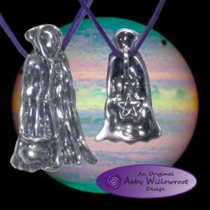 Two sterling silver hooded figure pendants with purple cords hanging in front of a multicolored circular backdrop