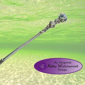 Ornate wand with shell and metalwork details against green sparkly background